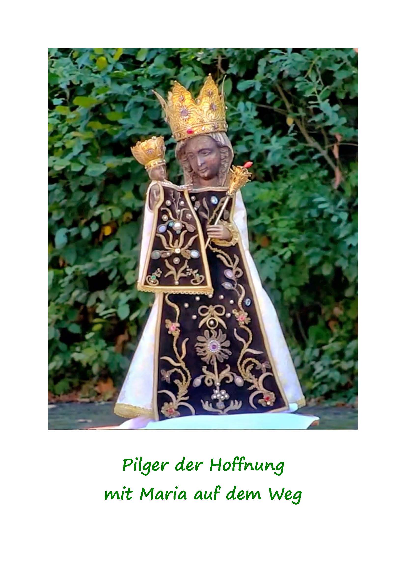 schwarze Madonna vor einer Hecke